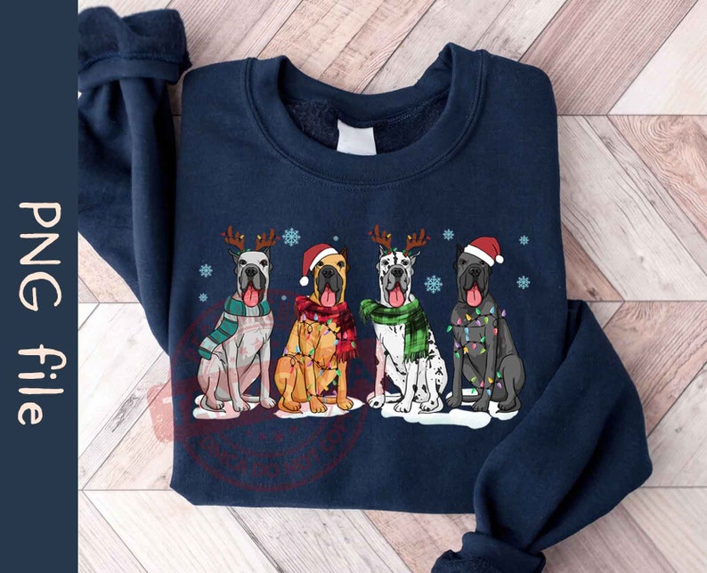 May include: A navy blue sweatshirt with a Christmas-themed design featuring four Great Danes wearing Santa hats and Christmas lights. The dogs are standing in a row, with their tails wagging.