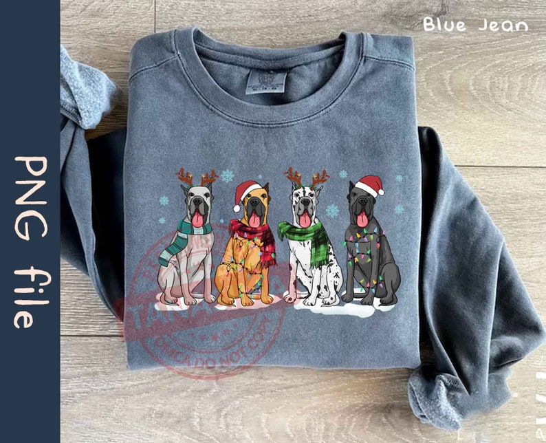 May include: A blue sweatshirt with a Christmas-themed design featuring four Great Danes wearing Santa hats and Christmas lights. The text "Blue Jean" is visible in the top right corner of the image.
