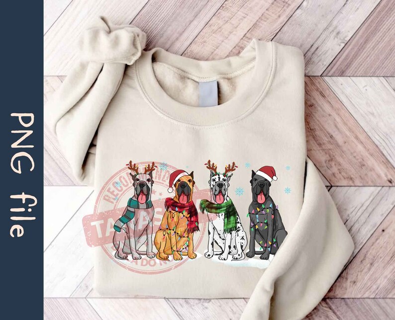 May include: A cream-colored sweatshirt with a Christmas-themed design featuring four Great Danes wearing Santa hats and reindeer antlers. The dogs are decorated with Christmas lights and snowflakes. The text "Recognize the Tatas" is printed on the sweatshirt.
