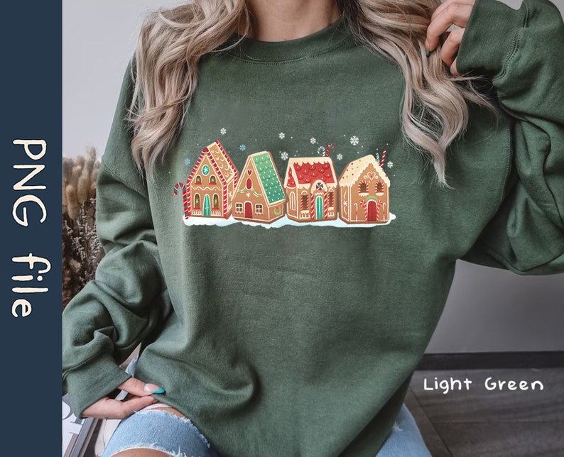 May include: A light green sweatshirt with a festive design of gingerbread houses. The houses are decorated with candy and icing. The text "Light Green" is visible in the bottom right corner of the image.
