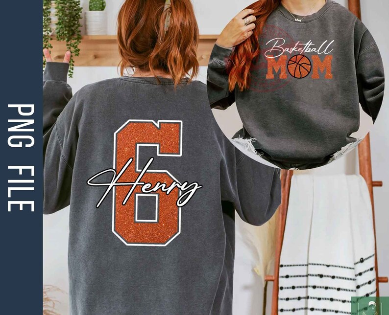 May include: A gray sweatshirt with an orange glitter number 6 and the name "Henry" in white script. The sweatshirt is shown on a model from the back. A second gray sweatshirt is shown on a model from the front with the text "Basketball Mom" and a basketball graphic in orange glitter.