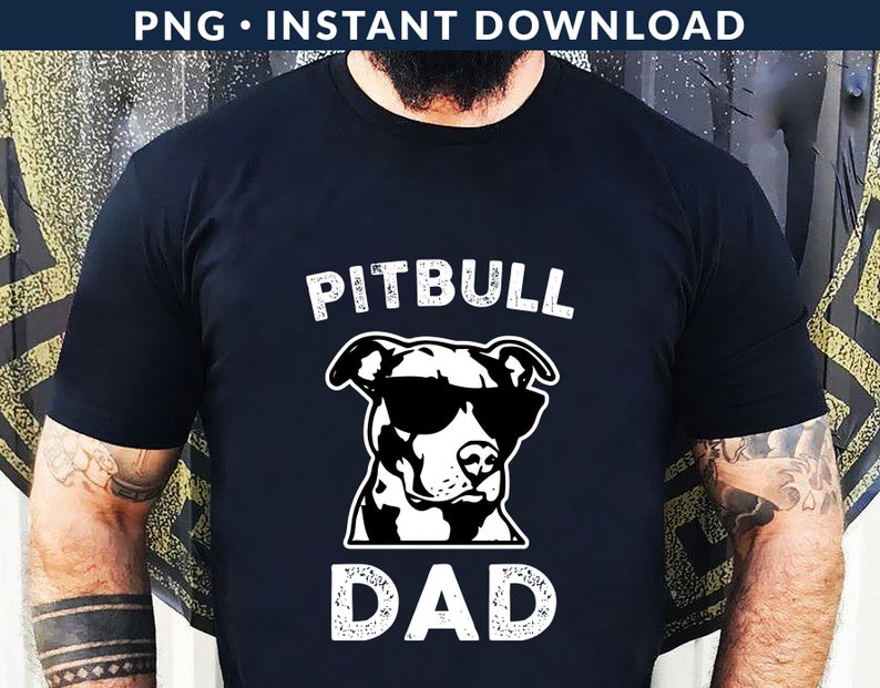 May include: Black t-shirt with a white graphic of a pitbull wearing sunglasses and the text "Pitbull Dad" in a distressed font.