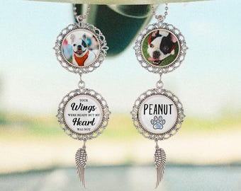 May include: Two silver car charms with dog photos. One charm has the text "YOUR WINGS WERE READY BUT MY HEART WAS NOT" and the other says "PEANUT" with a paw print. Each charm has a decorative filigree frame and a dangling wing.