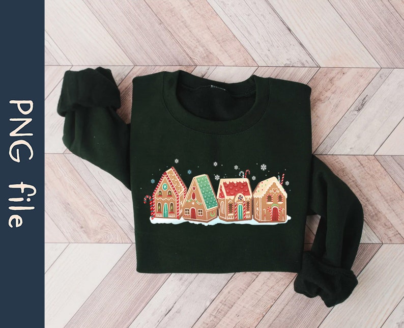 May include: A dark green sweatshirt with a festive design of gingerbread houses with white frosting and candy canes. The houses are arranged in a row and have red, green, and white accents.