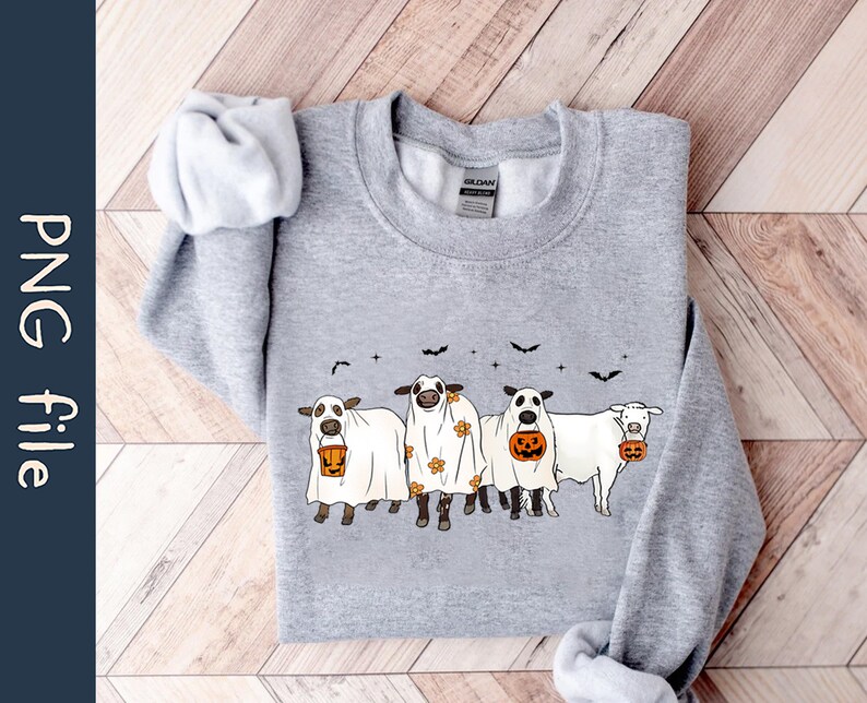 May include: A gray sweatshirt with a graphic of four cows dressed as ghosts holding jack-o'-lanterns. The cows are wearing white sheets with black eyes and mouths. The graphic is centered on the sweatshirt.