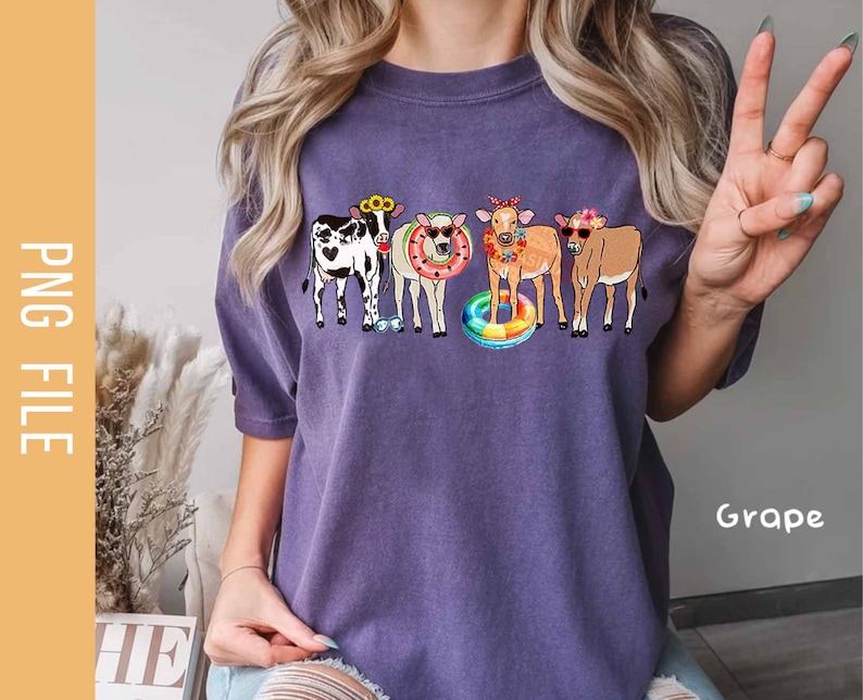 May include: Purple t-shirt with a graphic of four cows wearing sunglasses and floaties. The cows are wearing flowers in their hair. The text "Grape" is visible in the bottom right corner of the image.