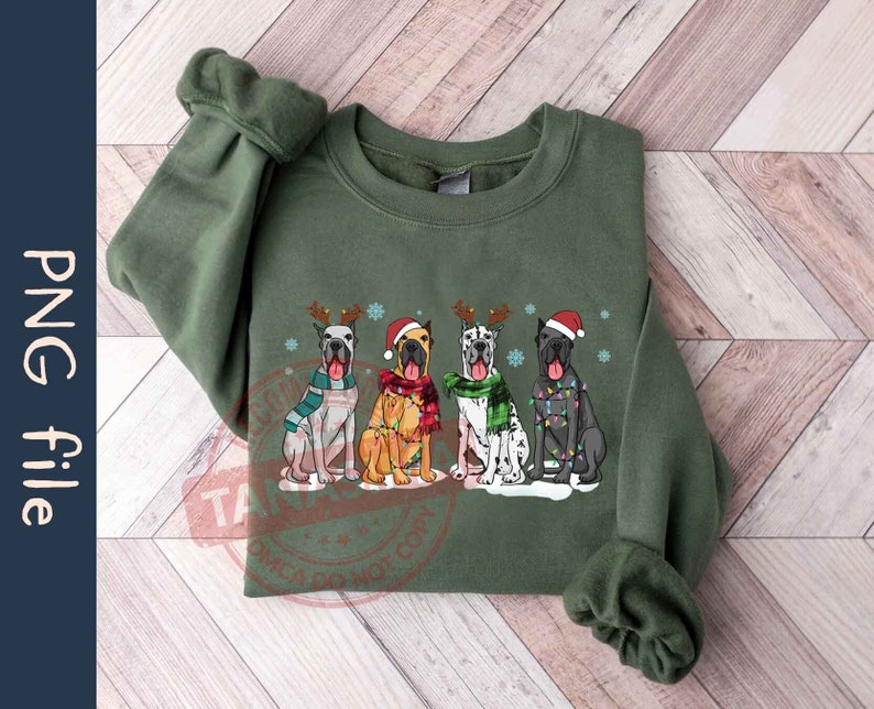 May include: Green sweatshirt with a Christmas-themed design featuring four Great Danes wearing Santa hats and scarves. The dogs are decorated with lights and snowflakes.