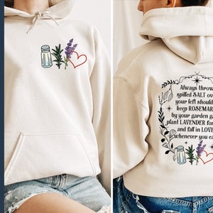 May include: A beige hoodie with a graphic print on the back that says "Always throw spilled SALT over your left shoulder. keep ROSEMARY by your garden gate, plant LAVENDER for luck and fall in LOVE whenever you can."