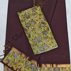 May include: A dark brown fabric set with a floral design. The set includes a large piece of fabric and two smaller pieces with a green and yellow floral pattern. The edges are trimmed with gold and brown accents.