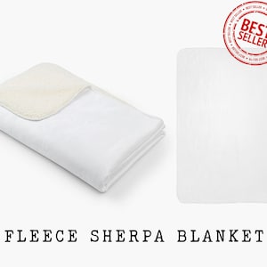 May include: A white fleece sherpa blanket folded in half. The blanket has a soft, plush texture and is perfect for cuddling up on the couch.
