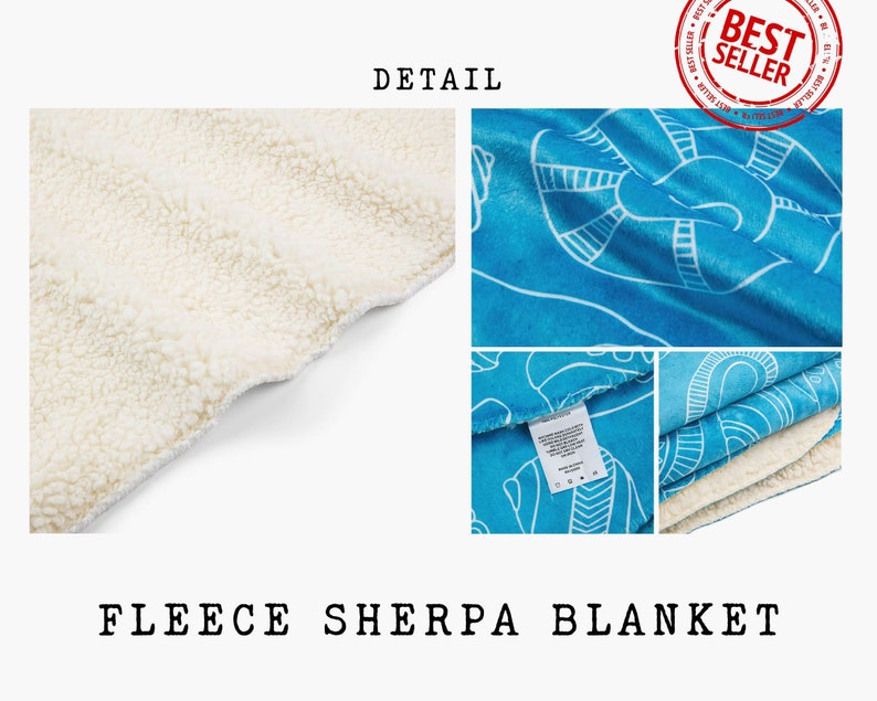 May include: A blue fleece sherpa blanket with a white sherpa lining. The blanket features a white geometric pattern on a blue background. The blanket is folded in half and the white lining is visible.