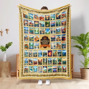 May include: A large, rectangular blanket featuring a collage of 63 National Parks images. The blanket has a gold border with a repeating pattern. A central emblem reads "63 National Parks".