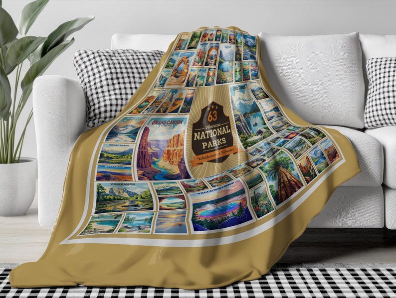 May include: A tan throw blanket with a collage of vintage postcard images of 63 National Parks. The blanket features a large, gold circle with the text "63 National Parks" and "Wilderness & Wonder".