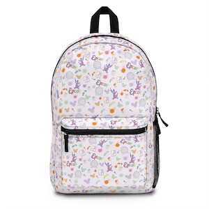 May include: White backpack with a black zipper and handle, featuring a colorful pattern of Epcot-themed icons and the word "Epcot". The design includes the Epcot ball, Figment, and other park-related imagery. A side mesh pocket is visible.