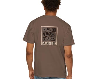 May include: A brown t-shirt with a black and white QR code and the text "SCAN ME" printed on the back.