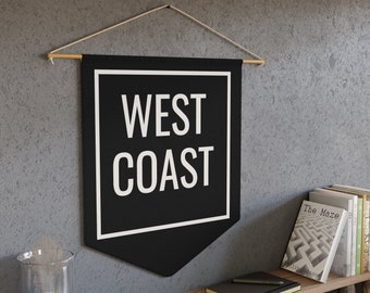 May include: Black and white banner with the text "WEST COAST" in a white square on a black background. The banner is hanging from a wooden dowel rod with string.