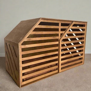 May include: A wooden dog crate with a slatted front and a solid side panel. The crate has a brown stain and a brown cushion inside.
