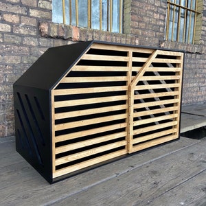 May include: A black and wood dog house with a slatted front door and a black accent on the side.