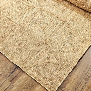 May include: A natural fiber rug with a woven diamond pattern. The rug is made of jute and has a light brown color.
