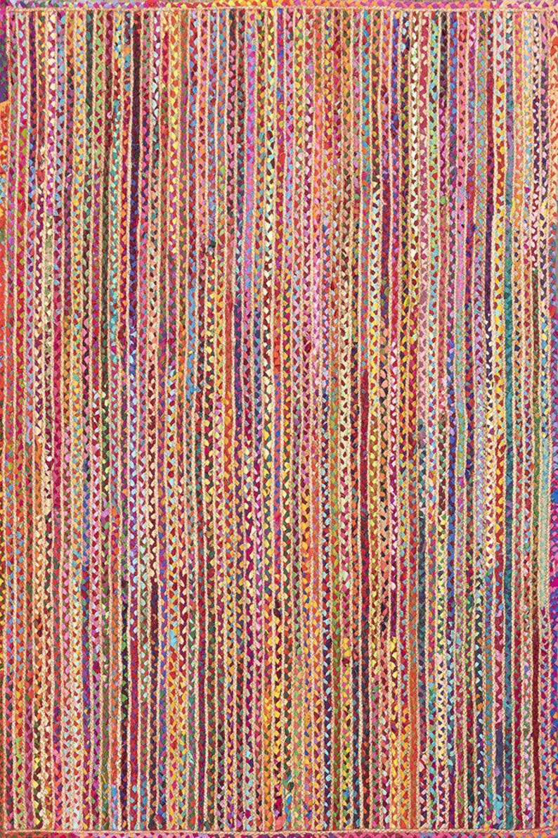 May include: A colorful, woven rug with vertical stripes in shades of red, orange, yellow, green, blue, and purple. The rug has a textured appearance, with each stripe appearing to be made of braided strands.