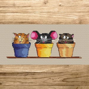 May include: Cross-stitch design featuring three cartoon animals in flower pots. The animals include a ginger cat in a blue pot, a black mouse with pink ears in a yellow pot, and a brown cat in a tan pot. The pots sit on a brown shelf.
