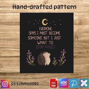 May include: A cross-stitch pattern on a black background with the text "Everyone says I must become someone but I just want to stay myself." The design includes a hedgehog, moon, stars, and flowers. The text "Hand-drafted pattern" is at the top.