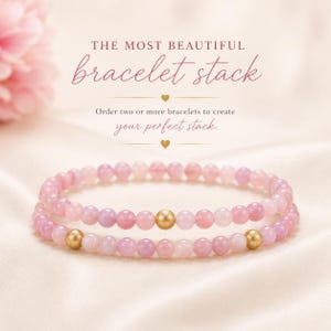 May include: Two beaded bracelets featuring light pink and lavender spherical beads. Each bracelet includes a single brushed gold-tone spherical bead. The text reads: THE MOST BEAUTIFUL bracelet stack. Order two or more bracelets to create your perfect stack.