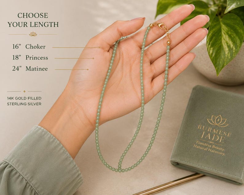 May include: A light green beaded necklace with a gold-filled sterling silver clasp. Text on the image reads: CHOOSE YOUR LENGTH, 16" Choker, 18" Princess, 24" Matinee, 14K GOLD FILLED STERLING SILVER, BURMESE JADE, Timeless Beauty, Natural Harmony.