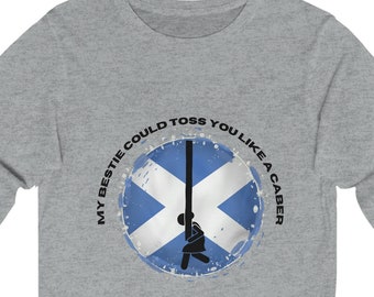 May include: Gray long-sleeve t-shirt with a circular graphic of a person tossing a caber, a Scottish Highland Games event. The graphic includes the text "My bestie could toss you like a caber" and a stylized Scottish flag.