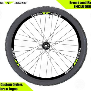 May include: A black and white bicycle wheel rim with a yellow and black sticker that says "CUBE ELITE". The sticker is on both sides of the rim. The text "Front and Rear INCLUDED" is at the top of the image.