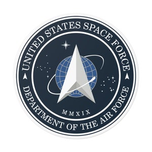 May include: A blue and white circular sticker with the text "United States Space Force Department of the Air Force" and a silver star with a globe inside. The year "MMXIX" is printed below the star.