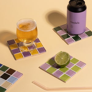 Square handmade coaster with a detailed glass and stone mosaic tile surface, ideal for protecting your furniture in style. This piece adds flair to any home, especially those with boho, modern, or artistic decor themes. Makes a lovely housewarming gift, holiday present, or desk accessory for anyone who enjoys handcrafted, eco-conscious, and visually striking home accents.