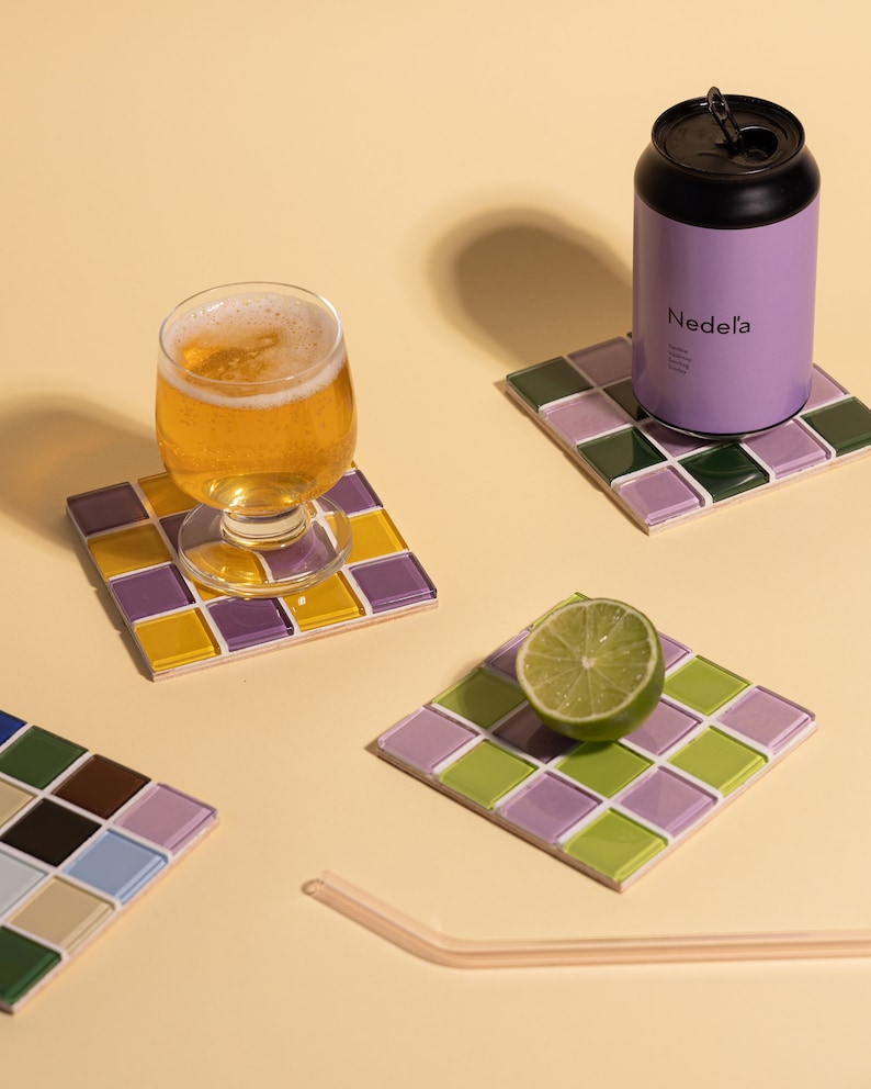 Square handmade coaster with a detailed glass and stone mosaic tile surface, ideal for protecting your furniture in style. This piece adds flair to any home, especially those with boho, modern, or artistic decor themes. Makes a lovely housewarming gift, holiday present, or desk accessory for anyone who enjoys handcrafted, eco-conscious, and visually striking home accents.