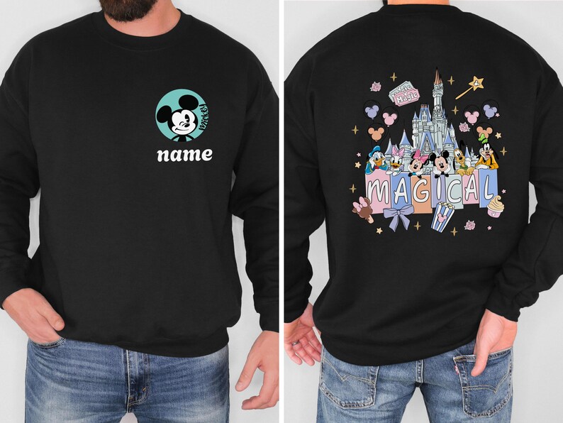 May include: Black sweatshirt featuring Mickey Mouse on the front with the word "name" below. The back of the sweatshirt displays a colorful graphic of a castle, Disney characters, and the word "MAGICAL".
