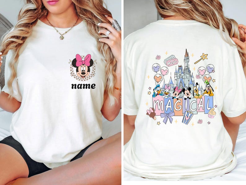 May include: Cream-colored t-shirt featuring Minnie Mouse with a pink bow and the text "name" on the front. The back of the shirt showcases a colorful graphic of Disney characters and a castle with the word "MAGICAL".
