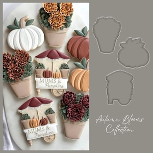 May include: An assortment of autumn-themed cookies, including pumpkins, flower arrangements, and a cart with the text "MUMS & Pumpkins." The cookies are decorated with shades of white, brown, orange, and green. The image also includes cookie cutter outlines.