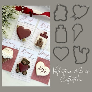 May include: Valentine's Day cookie cutters in various shapes, including a heart, bear, jar, ice cream cone, and a speech bubble. The cutters are made of metal and have a silver finish. The text "Valentine Minis Collection" is written in white on a gray background.