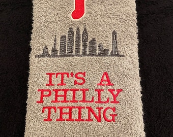 May include: Gray hand towel with red embroidered "P" and a skyline, and the text "IT'S A PHILLY THING" in red.