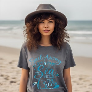 May include: A gray t-shirt with a blue graphic that says "Sail Away Let the Sea Set You Free". The graphic includes a seashell, a starfish, and a sailboat.