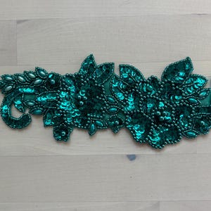 May include: A set of three ceramic mugs with a speckled, matte finish. The mugs are in shades of cream, light gray, and dark gray. Each mug has a simple, minimalist design and a rounded handle. Perfect for coffee or tea.