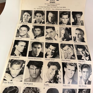 May include: A vintage promotional print from Elite Model Management featuring headshots of male models. The black and white images are arranged in a grid, with the agency's logo at the top. The print includes contact information for the agency.