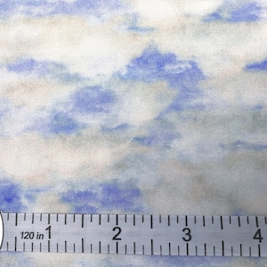May include: Close-up of fabric with a watercolor-style cloud pattern in shades of blue, white, and beige. A measuring tape shows 120 inches. The fabric has a soft, textured appearance, suitable for various craft projects.