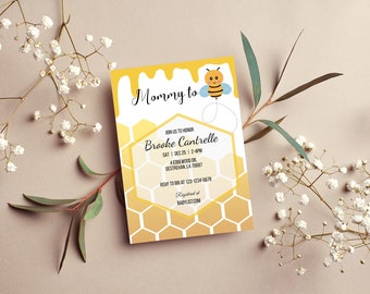 May include: A yellow and white baby shower invitation with a cartoon bee and honeycomb pattern. The text reads "Mommy to" and "Brooke Cantrelle".