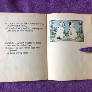 May include: Two white dogs with black spots are sitting on a green patch of grass. They are facing each other. There are pink flowers and green leaves behind them. The text on the page reads: 'And when they got back home they were A sorry sight to see, All streaked with mud and soaking wet And cold as they could be. Old Billy Goat just wagged his beard And saw them slink away; 'I think,' he said, 'those dogs have learned A thing or two today.'
