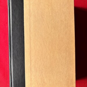 May include: A brown hardback book with a black spine.