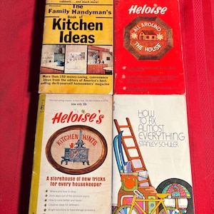 May include: Four vintage paperback books with colorful covers. The books are titled "The Family Handyman's Book of Kitchen Ideas", "Heloise All Around The House", "Heloise's Kitchen Hints", and "How To Fix Almost Everything".