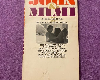 May include: A well-worn paperback book, "John & Mimi: A Free Marriage" by John and Mimi Lobell. The cover displays the title in orange and purple, with a photograph of a couple. The book's subtitle promises a controversial blueprint for sexual exploration.