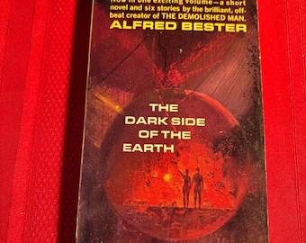 May include: A vintage paperback book cover with a dark red and orange illustration of a planet with two figures standing on it. The title is "The Dark Side of the Earth" by Alfred Bester.