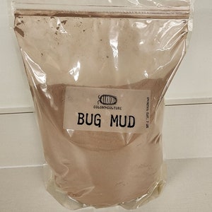May include: A clear plastic bag filled with brown bug mud. The bag has a label that says "Colony Culture" and "Bug Mud". The label also says "Snail Trail Clay, 3 lbs."