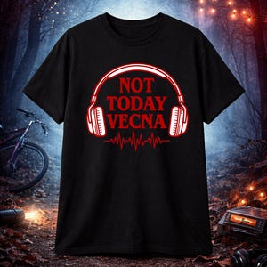 May include: Black t-shirt with a red and white graphic. The graphic features a pair of headphones with the words "NOT TODAY VECNA" in red, and a red heartbeat line. The shirt is displayed against a dark, forest-like background.
